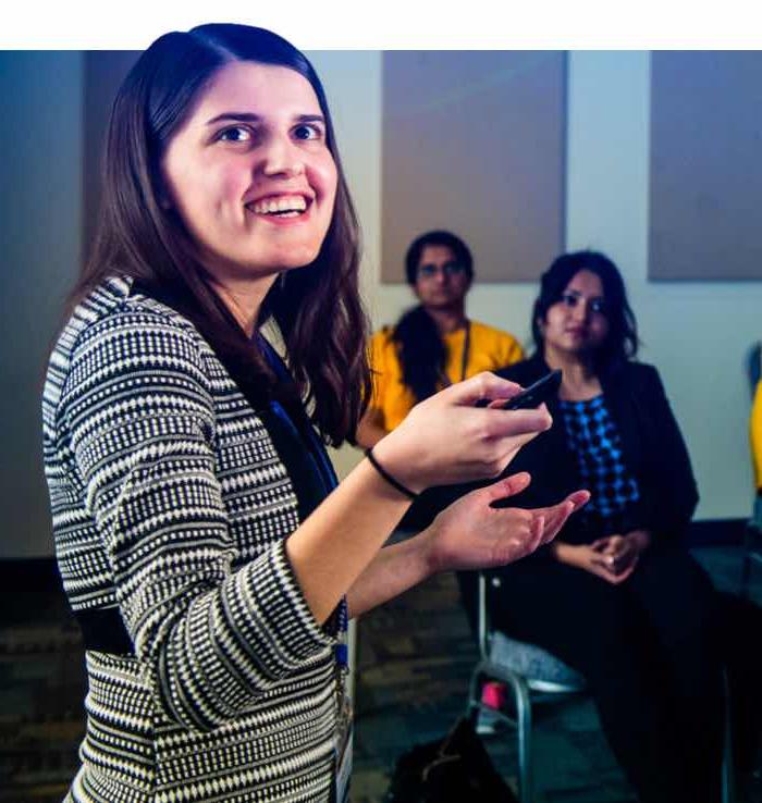 A student presenting in front of an audiance.